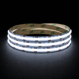 Cool White 6500K 24V 10mm COB LED strip shown illuminated in a coil on a dark background.