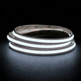 Cool White 6500K Free Cut COB LED strip coil illuminated on a dark background, 24V DC and 10mm wide.