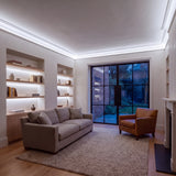 Daylight 5000K Free Cut COB LED strip ceiling coving lighting in a large British living room in the evening; installation illustration.