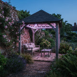 Purple RGB neon flex recessed beneath a roofed cedar garden seating structure