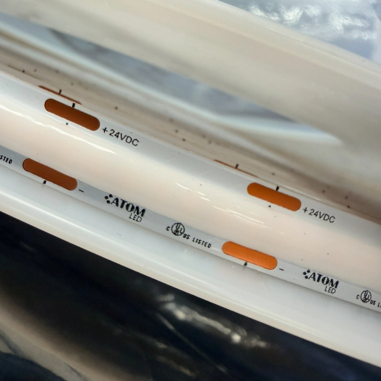 Close-up of SCOB strip copper solder pads, polarity markings and 24V DC connections