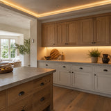 Illustrative oak kitchen with 2700K warm-white SCOB LED lighting in ceiling coving and above a dry worktop
