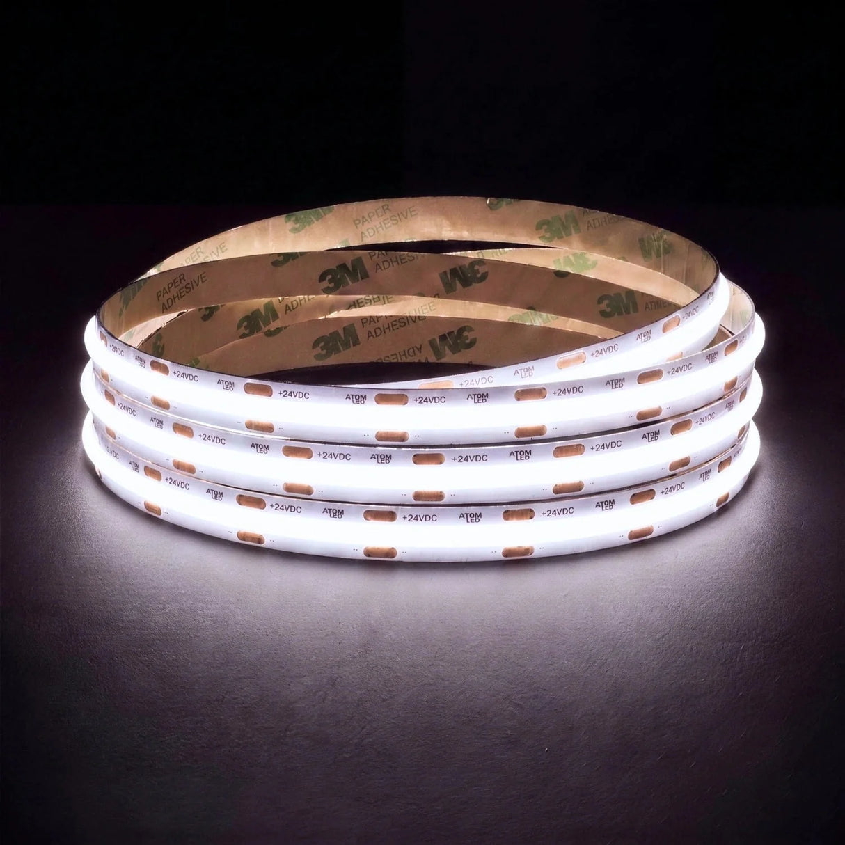 Daylight 5000K SCOB LED strip coil illuminated on a dark background, 24V DC and 10mm wide.