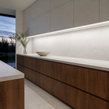 Illustrative white-and-walnut kitchen with cool-white 6500K SCOB LED lighting beneath cabinets over a dry preparation counter.