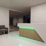 Green SCOB LED strip lighting beneath a pale stone and oak gym reception counter beside glass exercise rooms; installation illustration.