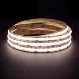 Natural white 4000K SCOB LED strip coil illuminated on a dark background, 24V DC and 10mm wide, with copper connection pads