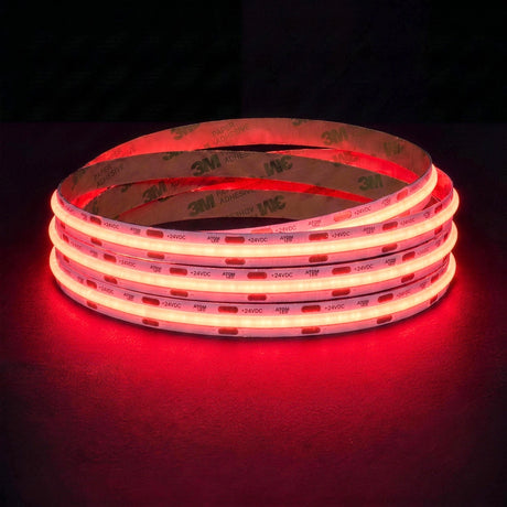 Red SCOB LED strip coil illuminated on a dark background, 24V DC and 10mm wide, with copper connection pads