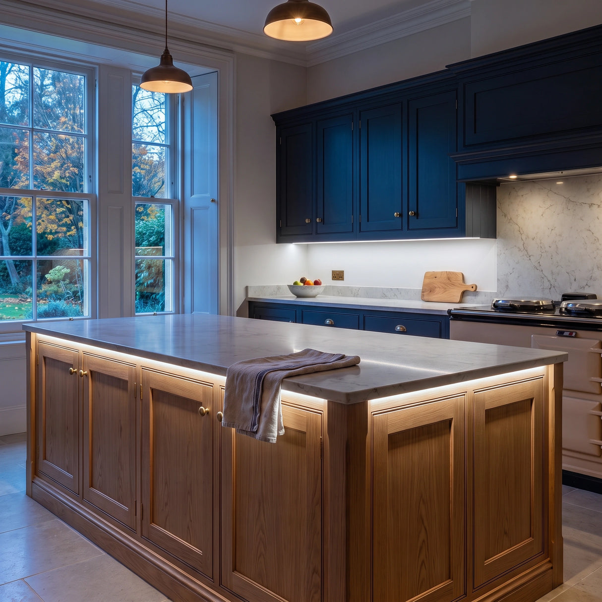 Daylight 5000K 24V 10mm COB LED strip installed beneath cabinets and around a British kitchen island; installation visual.