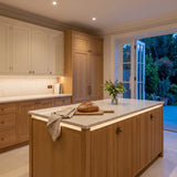 Warm White 3000K 24V 10mm free cut COB LED strip installed beneath cabinets and around a British kitchen island; installation visual.