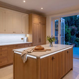 Cool White 6500K 24V 10mm free cut COB LED strip installed beneath cabinets and around a British kitchen island; installation visual.