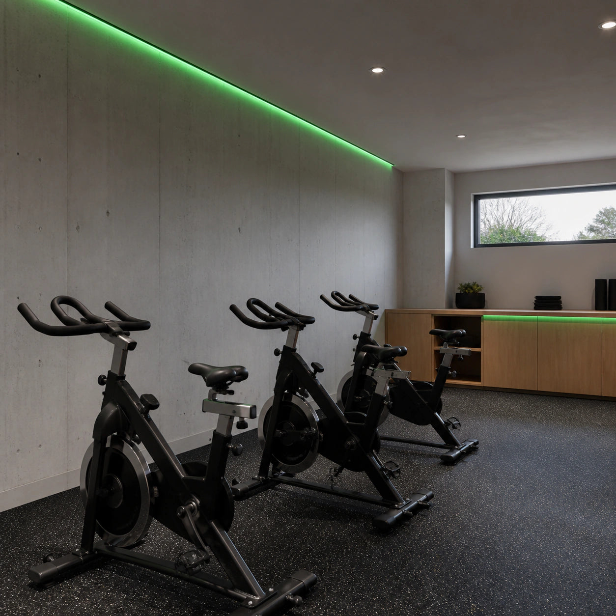 Green colour-changing LED gym lights installed in a spin cycling studio